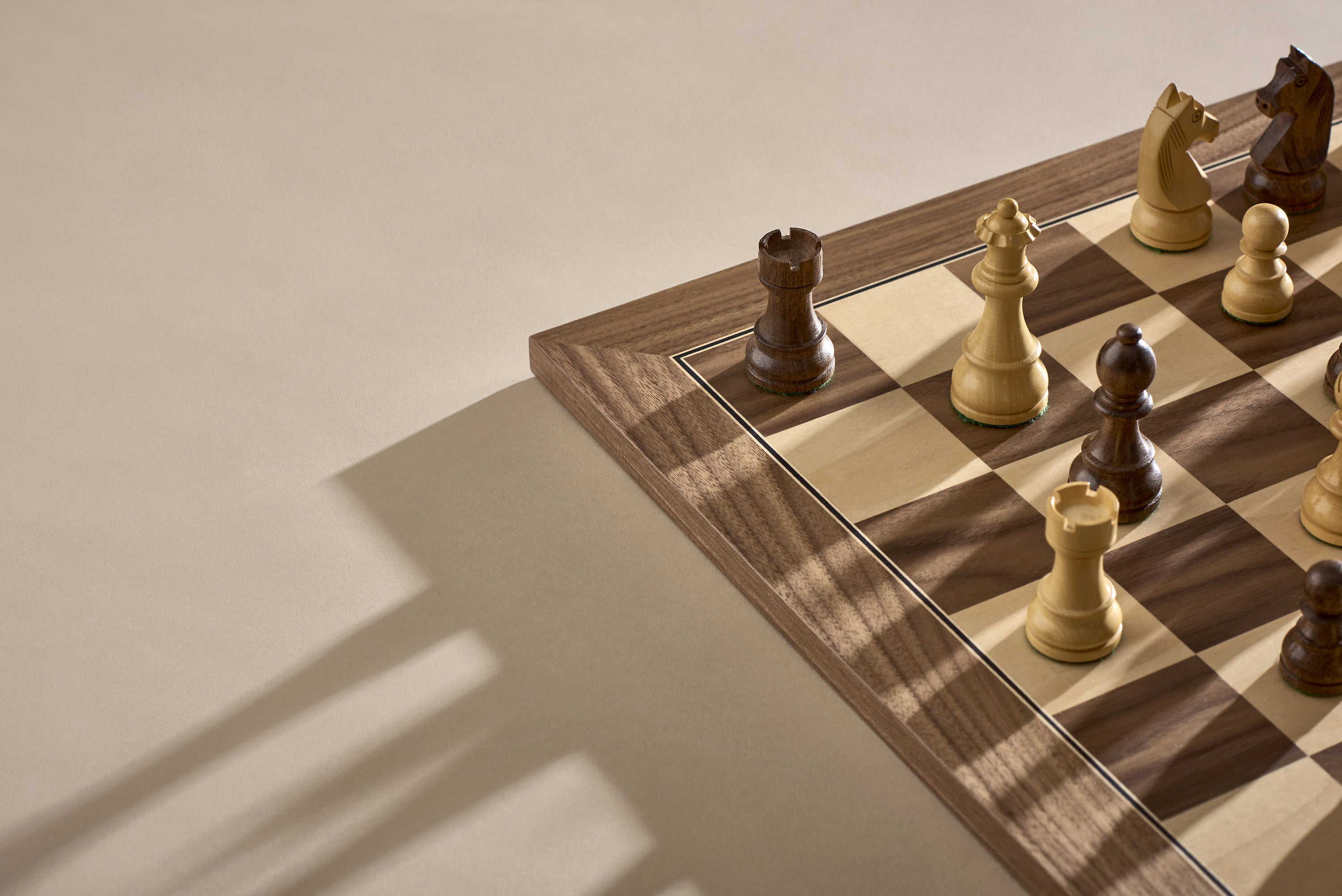 A chess board featuring a single wooden chess piece placed prominently on top.